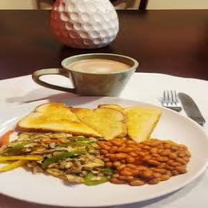 Milo with bread, egg,sausage and baked beans.